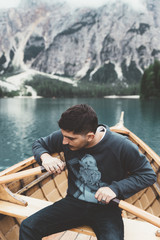Man rowing a wood boat at Braies lake - 121582419