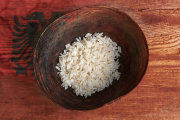 Poverty concept, bowl of rice with Albanian flag