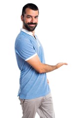 Man with blue shirt presenting something