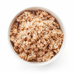 Bowl of rye flake porridge isolated on white, from above