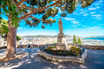 Beautiful park with cityscape view on Cannes city on the french riviera - obrazy, fototapety, plakaty