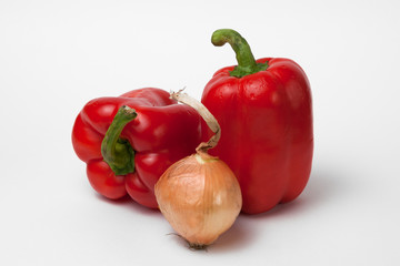 Two red bell peppers and an onion