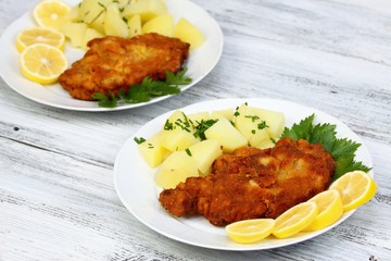 Wiener schnitzel & boiled potatoes, sliced lemon 