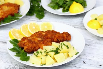 Wiener schnitzel & boiled potatoes, sliced lemon & lettuce
