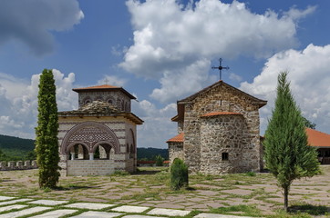 View of inner  yard with old medieval church, alcove and  bell tower  in restored Montenegrin or Giginski monastery  St. St. Cosmas and Damian, mountain  Kitka, Breznik, Pernik region, Bulgaria 