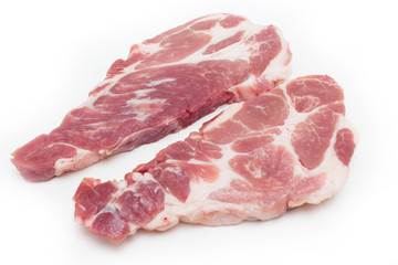 Two raw plump  pork neck chops on white