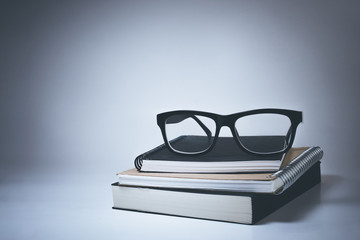  Glasses on notebook in white