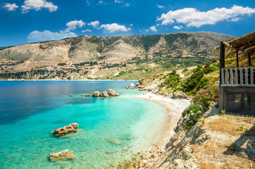 Vouti beach, Kefalonia island, Greece. People relaxing at the beach. The beach is surrounded by flowers.