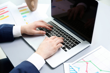 Businessman working with schedule and laptop in office