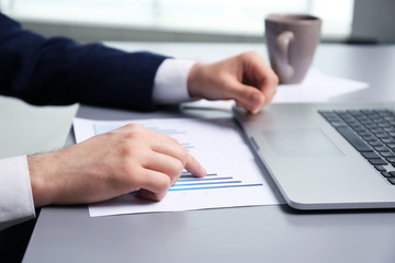 Businessman working with schedule and laptop in office