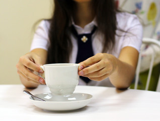 The girl is holding morning coffee, women's hands.