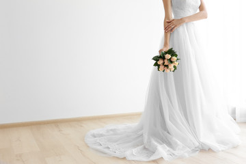 Bride in beautiful dress holding wedding bouquet
