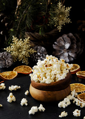popcorn in a wooden plate on the background of Christmas