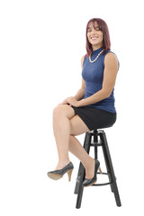 pretty young woman sitting on a stool