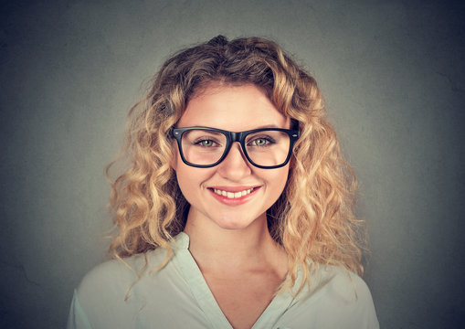 Headshot of a happy smiling woman in glasses