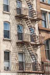 Fototapeta na wymiar External fire escape staircase on old brick building