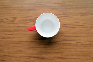 Red cup coffee / Empty red cup coffee on wood table. Top view.