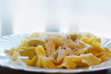 Ravioli filled with spinach and ricotta, Italian egg pasta, with fresh goat cheese on top