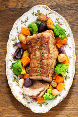 Roast pork with vegetables and spices.