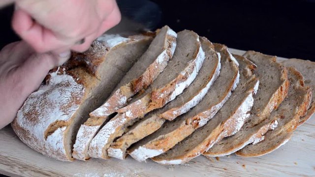 Krosses frisches Brot wird angeschnitten