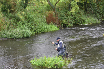 Fototapeta na wymiar Upper view of fly fisherman fishing in river