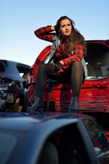 long-haired brunette girl posing in a car scrappage