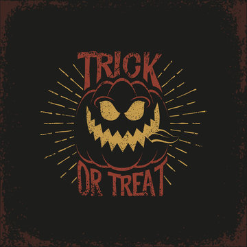 Vintage lettering with a Halloween pumpkin and the words "trick or treat" and sunburst on a dark background. Vector illustration. Grunge texture on separate layers.