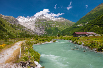 Swiss Alps valley near Gletch with Furka pass mountain road, Switzerland