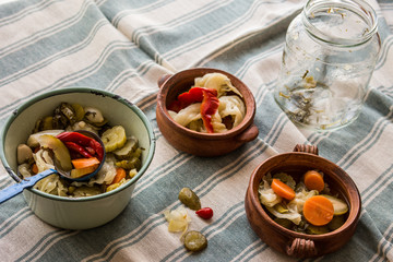 Mix of Turkish Pickles with green tomatoes, red pepper, cucumber and carrot in a bowl.