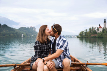 Tourist traveling by traditional wooden boat on the Lake Bled, Slovenia