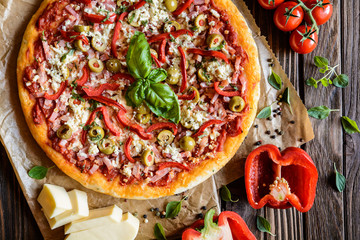 Pizza au jambon, bacon, olives, poivre et fromage