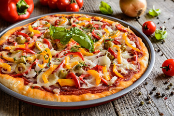 Salami pizza with green olives, pepper, onion and Edam cheese