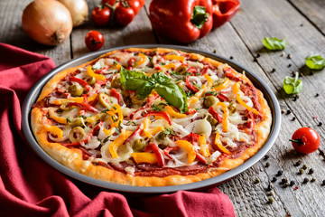Salami pizza with green olives, pepper, onion and Edam cheese