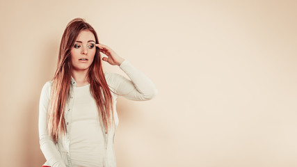 Fototapeta premium Worried woman with hand on head