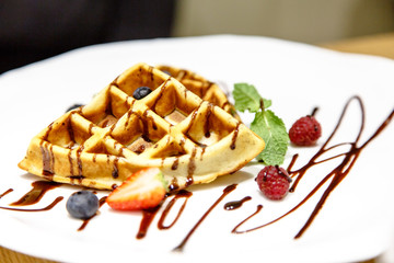 Viennese waffles drizzled with chocolate sauce  berries on a