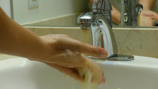 Closeup woman wahing hands sink