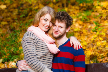 Fototapeta premium Lovers couple in autumn park on bench