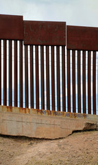 US-Mexican border as seen from Nogales, Mexico. The Spanish graffiti translates: "We are a people without borders".
