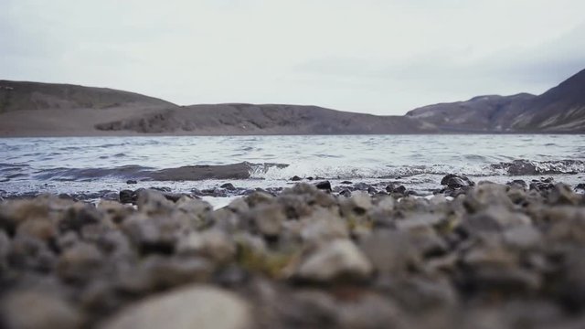 Sea waves on stone beach in Iceland