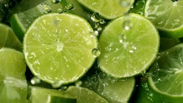 Limes Cut  with Water Drops Super Slow Motion 