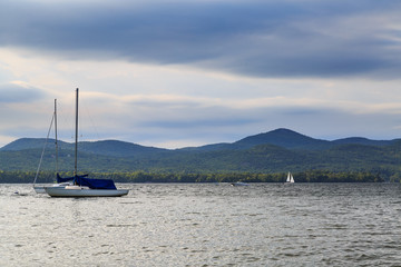 Fototapeta na wymiar Lake George NY shore line and beach with multiple boats in after