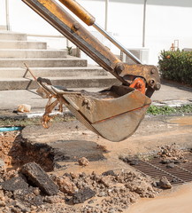 Excavator working on the Repair of  pipe water