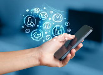 Hand holding smartphone with mobile app choices