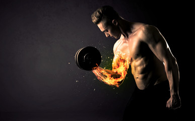 Bodybuilder athlete lifting weight with fire explode arm concept