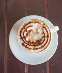 Top view Cup of coffee in a white cup on wooden table