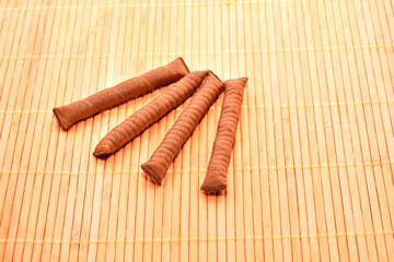 Chocolate sticks on wood background