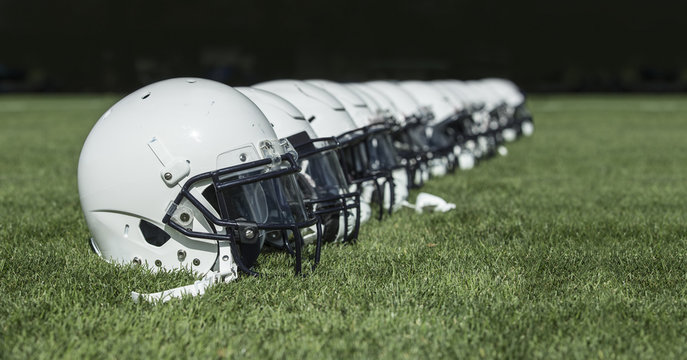 Row of American football Helmets before a game. Football abstract photo with copy space