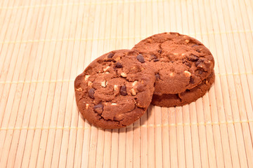 Fresh biscuits with chocolate on wood background