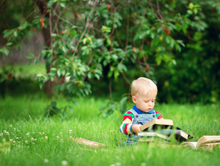one year old baby reading a book