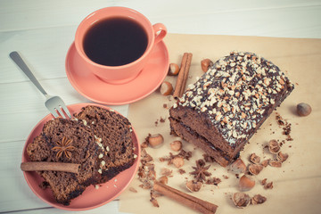 Vintage photo, Dark cake with chocolate, cocoa and plum jam, cup of coffee, delicious dessert